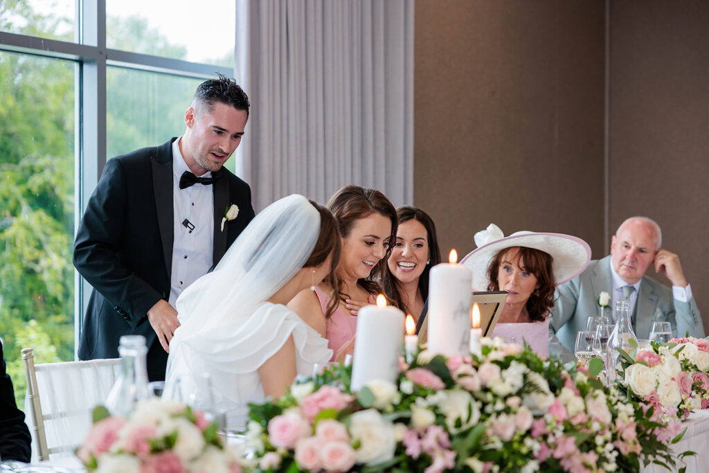 bridal party checking out family frame