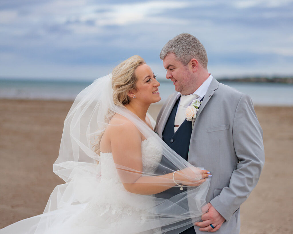 Bride and Groom embraced on Enniscrone beach during their wedding at the Diamond Coast Hotel enniscrone co.sligo