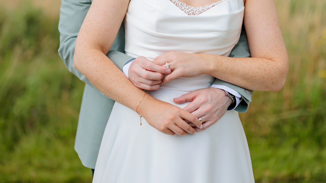 groom standing behind bride holding her hand at the Radisson Blu Hotel Sligo wedding of Kate and Tomas