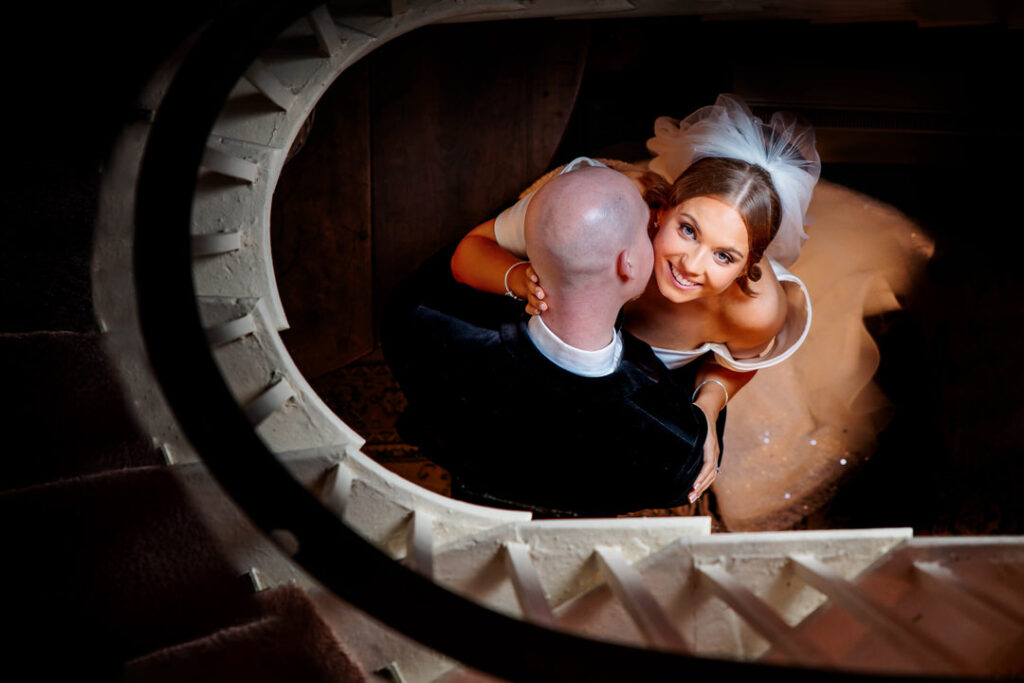 bride looking up as staircase surrounds them